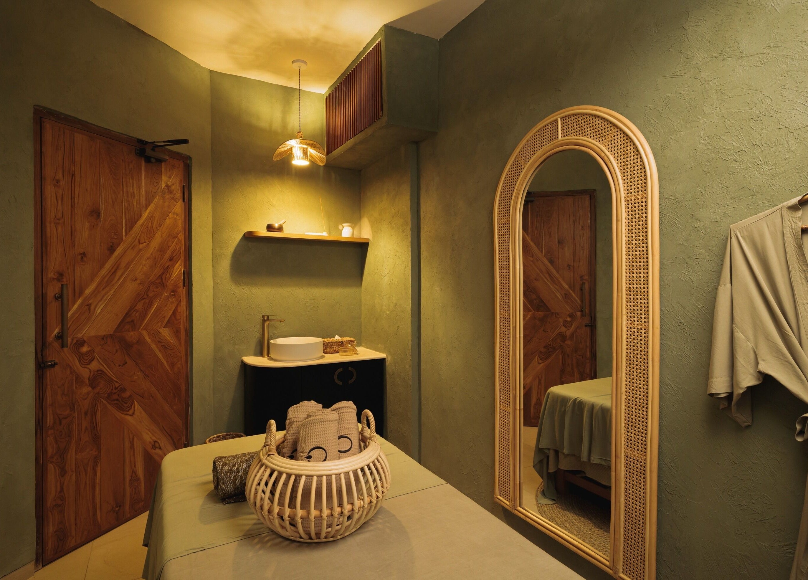 Cozy treatment room at You Spa Umalas, Bali, Bali, ID featuring soft lighting, elegant decor, and plush robe.