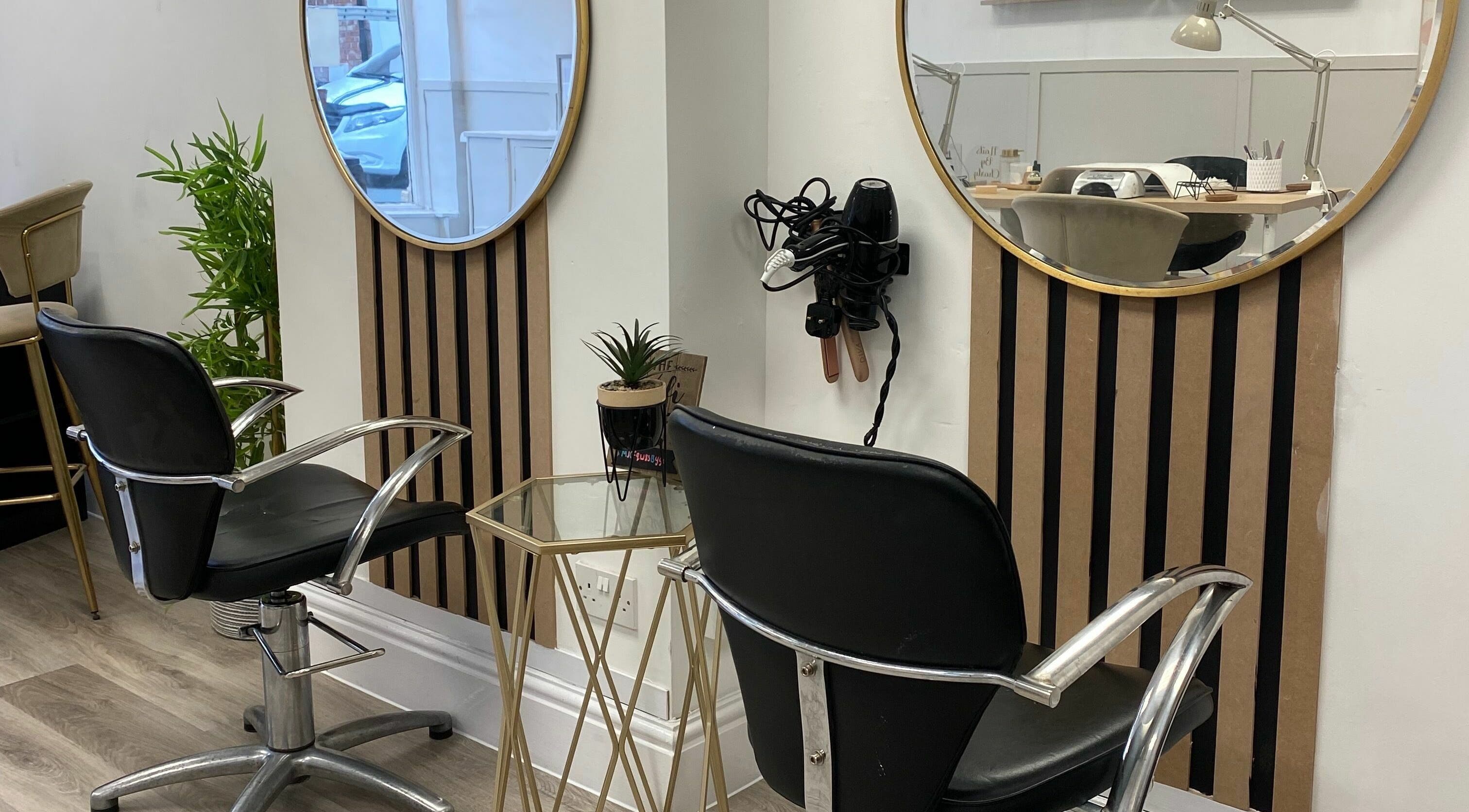 Elegant salon interior at The Look Hair and Beauty, Hyde, England, GB with modern chairs and mirrors.