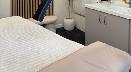 Comfortable treatment room at Blush and Bloom Cosmetics in Nantwich, England, GB with plush bedding.