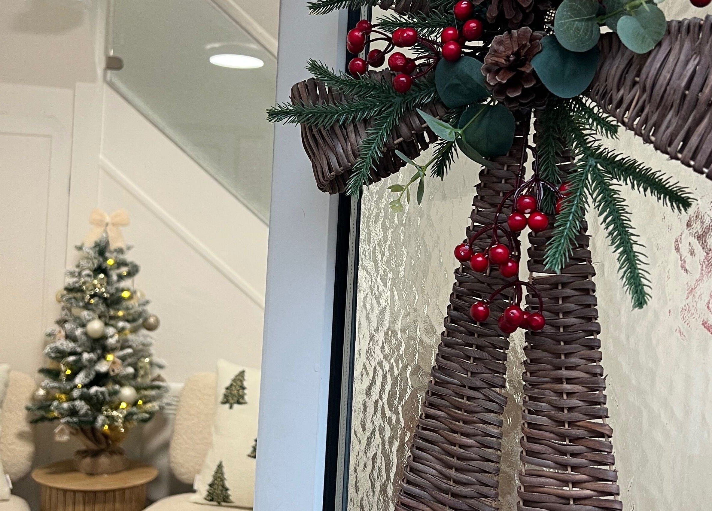Festive decor at Blush and Bloom Cosmetics, Nantwich, England, GB featuring a woven wreath and Christmas tree.