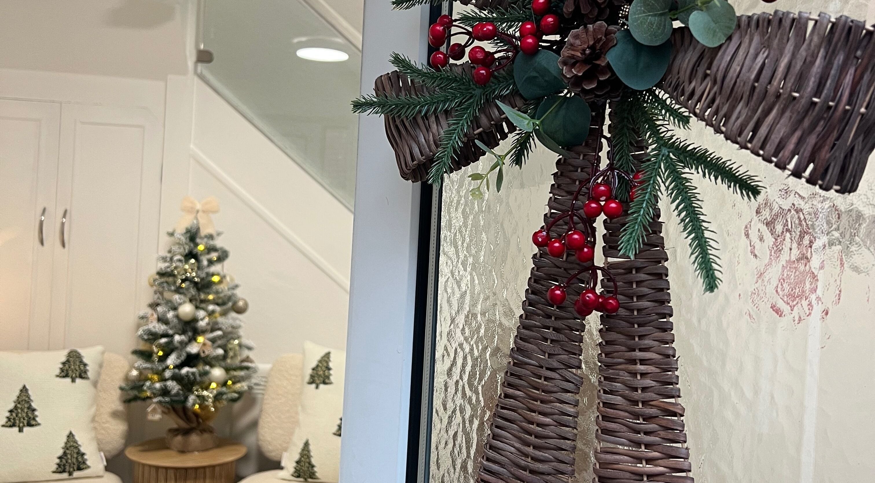 Festive decor at Blush and Bloom Cosmetics, Nantwich, England, GB featuring a woven wreath and Christmas tree.