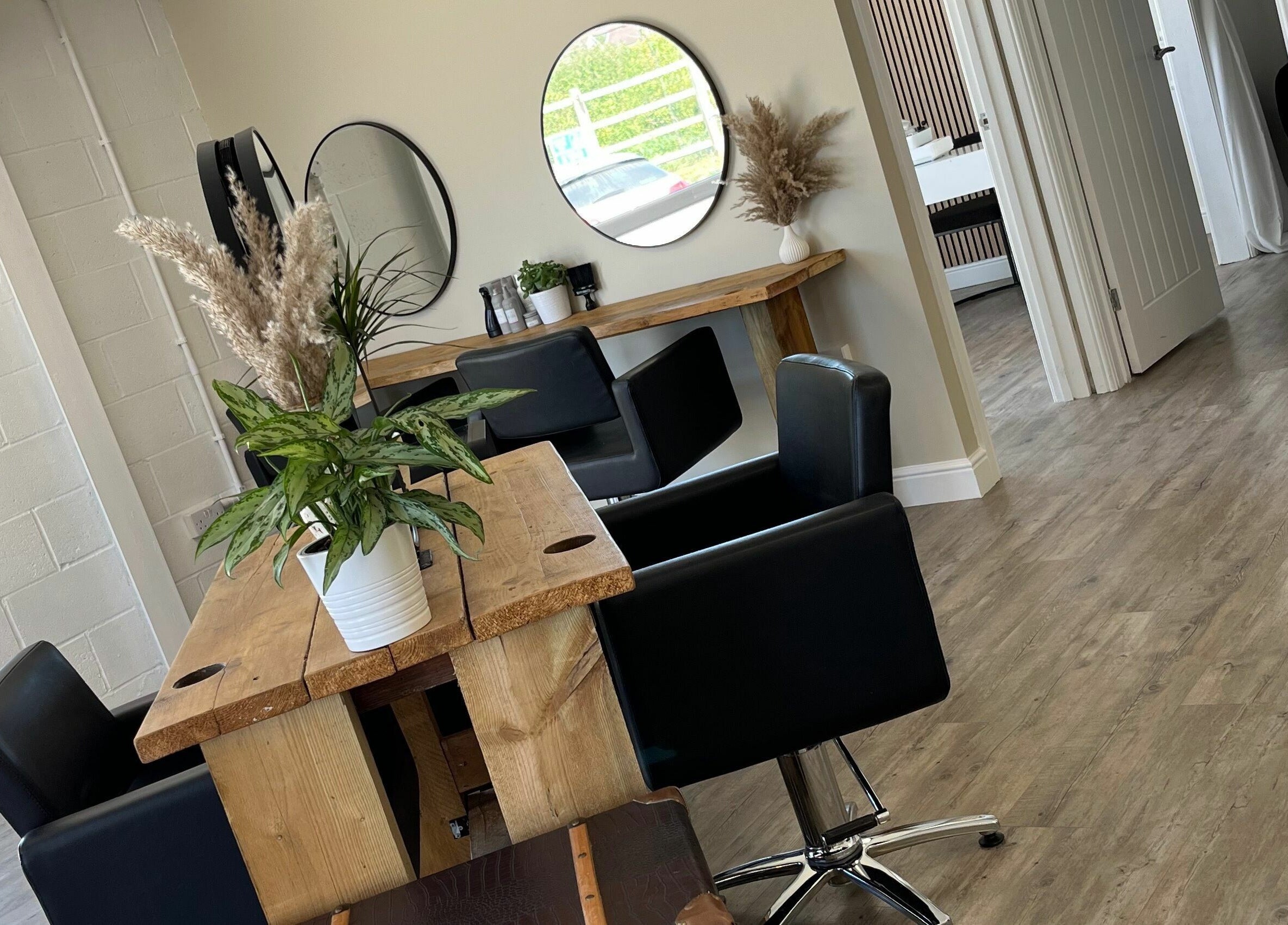 Interior of Stef Hayes Hair, Bude, England, featuring modern decor and styling chairs.