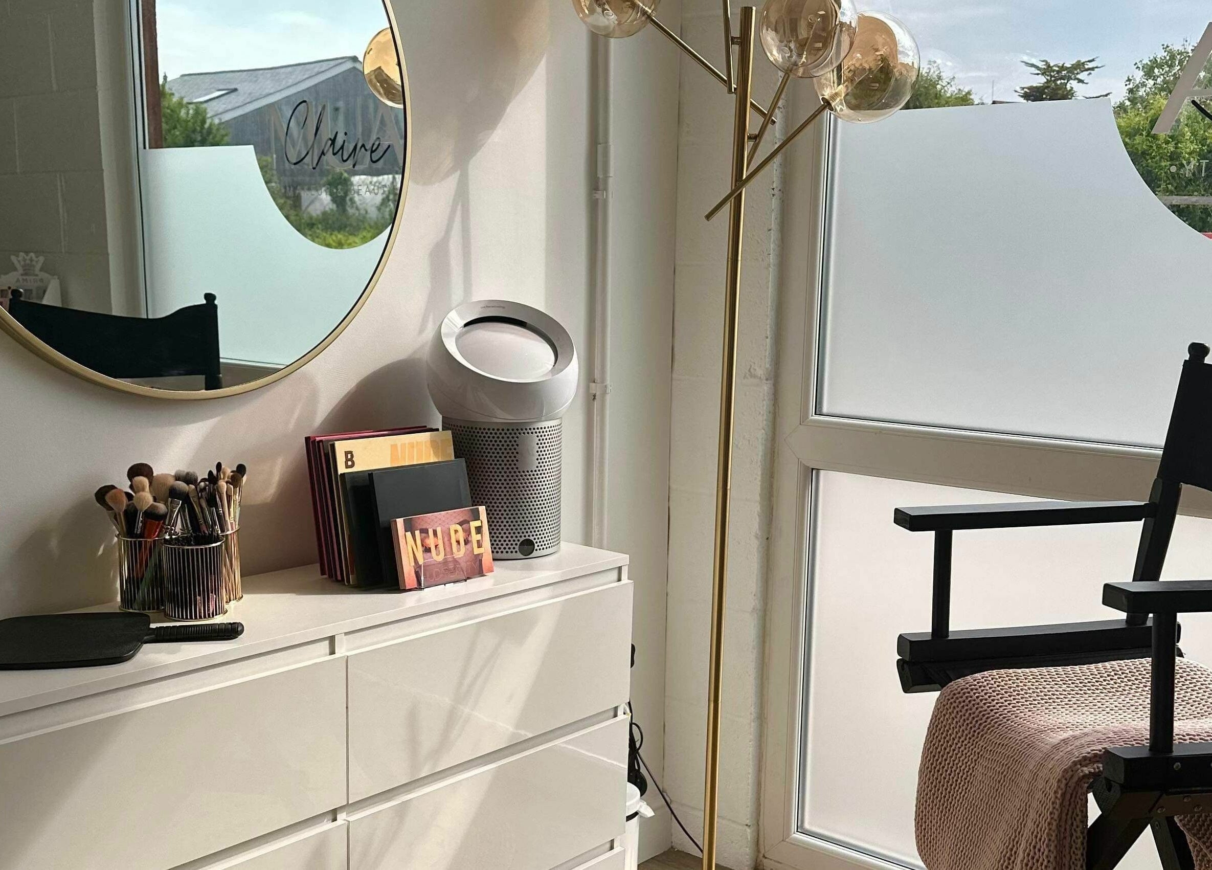 Bright makeup station at Stef Hayes Hair, Bude, England, GB with mirror and stylish decor.