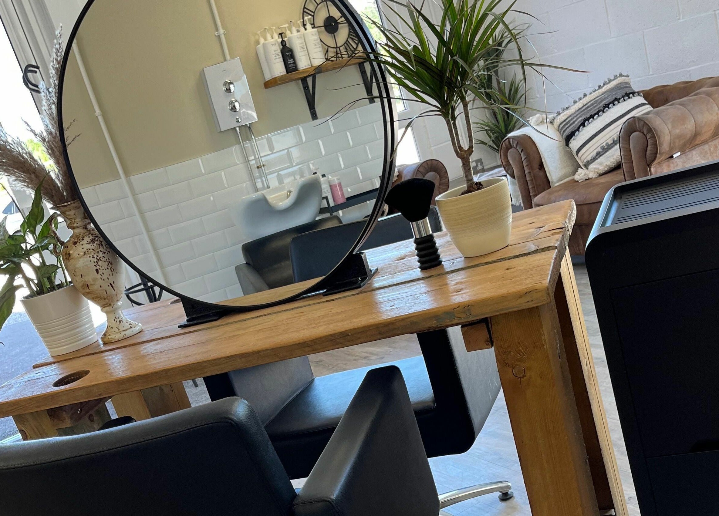 Elegant styling area at Stef Hayes Hair, Bude, England, GB with plants and rustic decor.