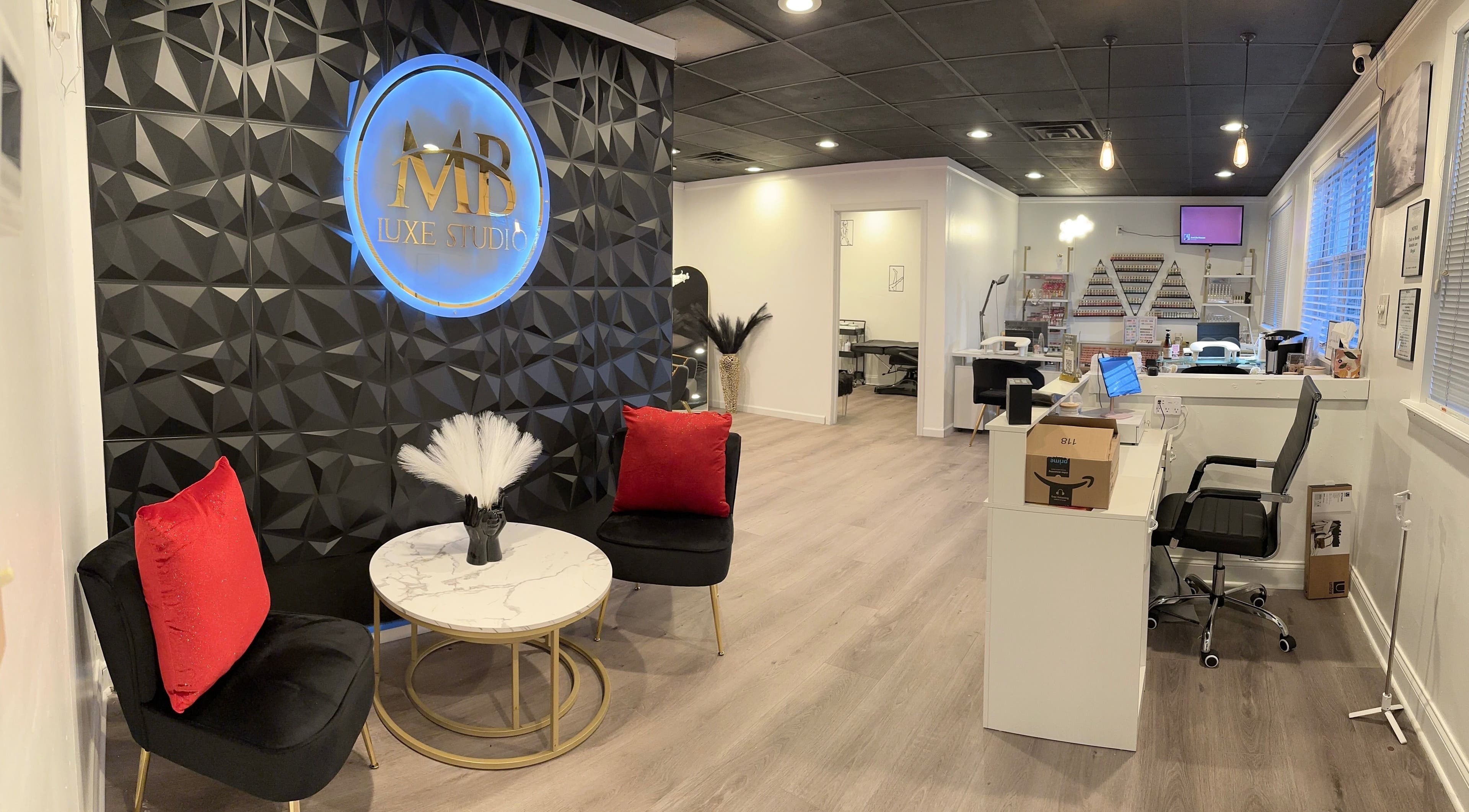 Elegant interior of MB Luxe Studio in Shrewsbury, New Jersey, US featuring chic black and red decor.