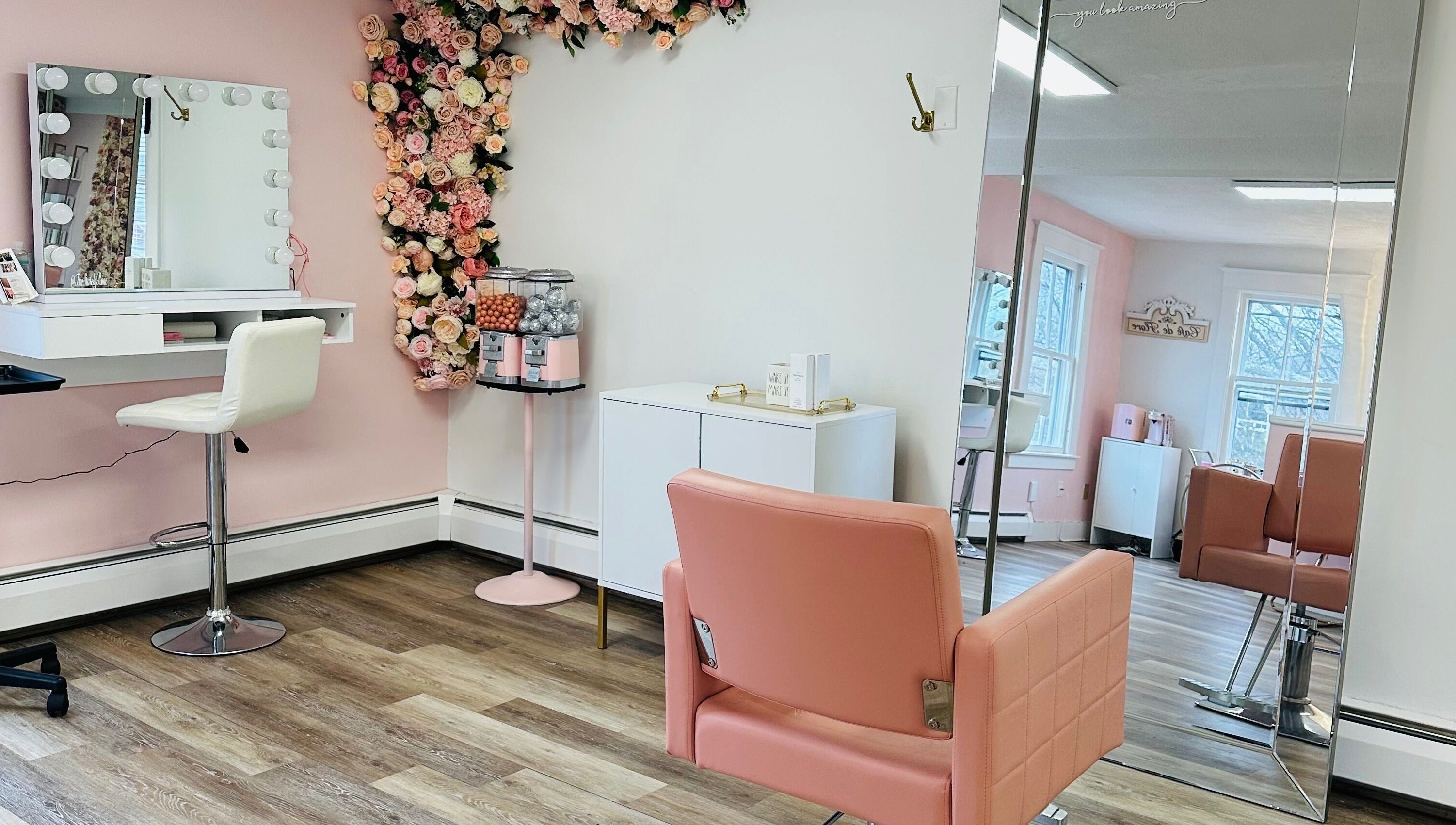 Chic interior of The Stately Rose Beauty Studio in Avon, Connecticut, US with pink decor and floral accents.