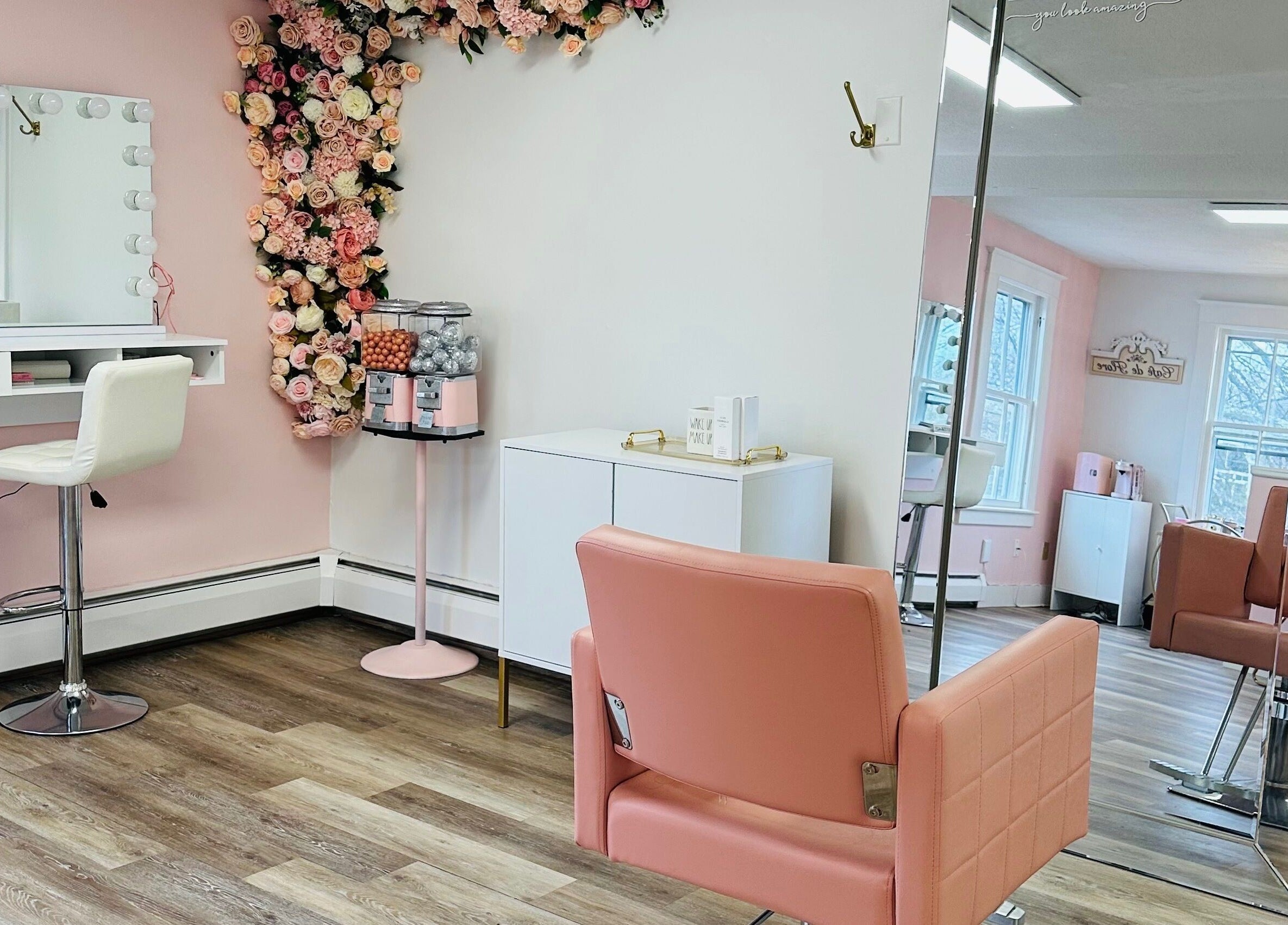 Chic interior of The Stately Rose Beauty Studio in Avon, Connecticut, US with pink decor and floral accents.