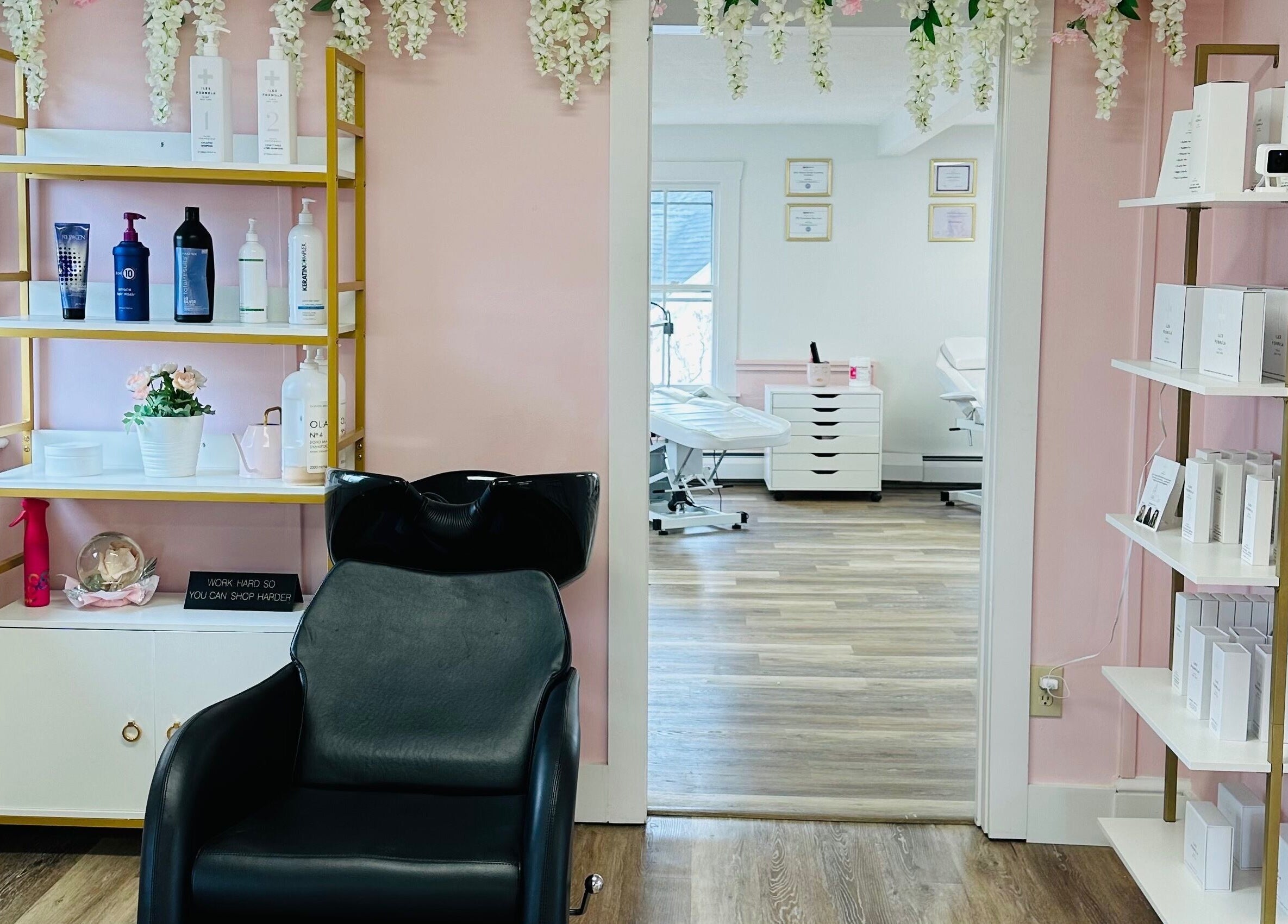 Modern salon interior at The Stately Rose Beauty Studio in Avon, Connecticut, US. Shelving with beauty products.