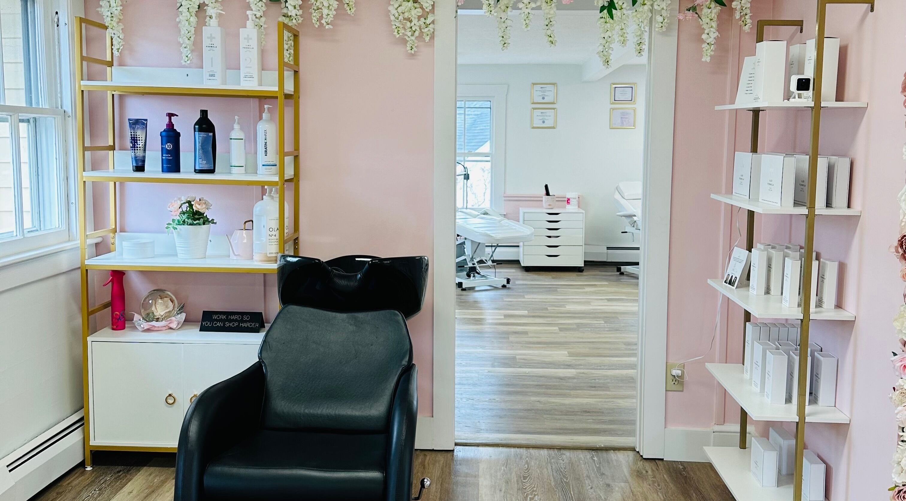 Modern salon interior at The Stately Rose Beauty Studio in Avon, Connecticut, US. Shelving with beauty products.