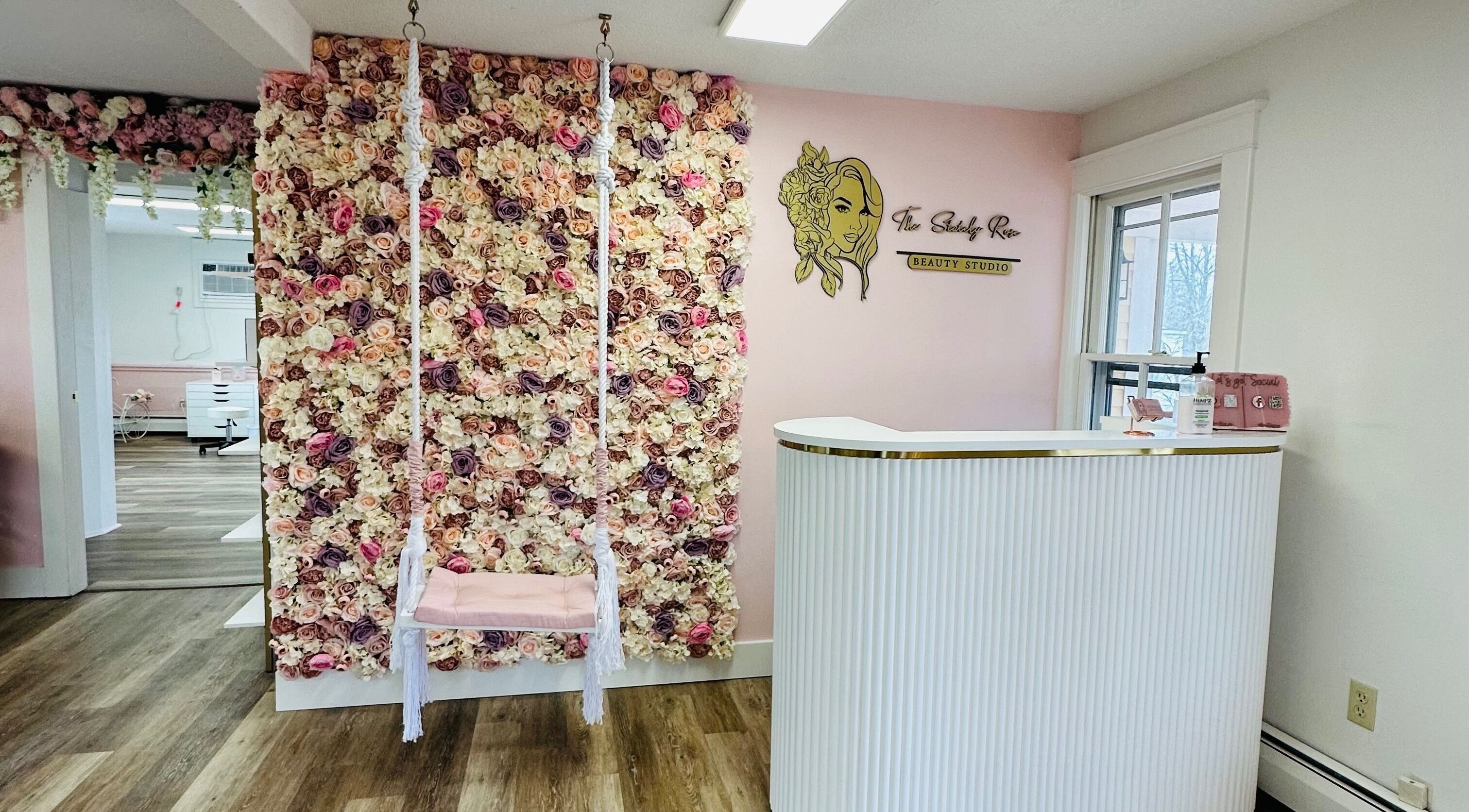 Entrance with floral wall and swing at The Stately Rose Beauty Studio in Avon, Connecticut, US.
