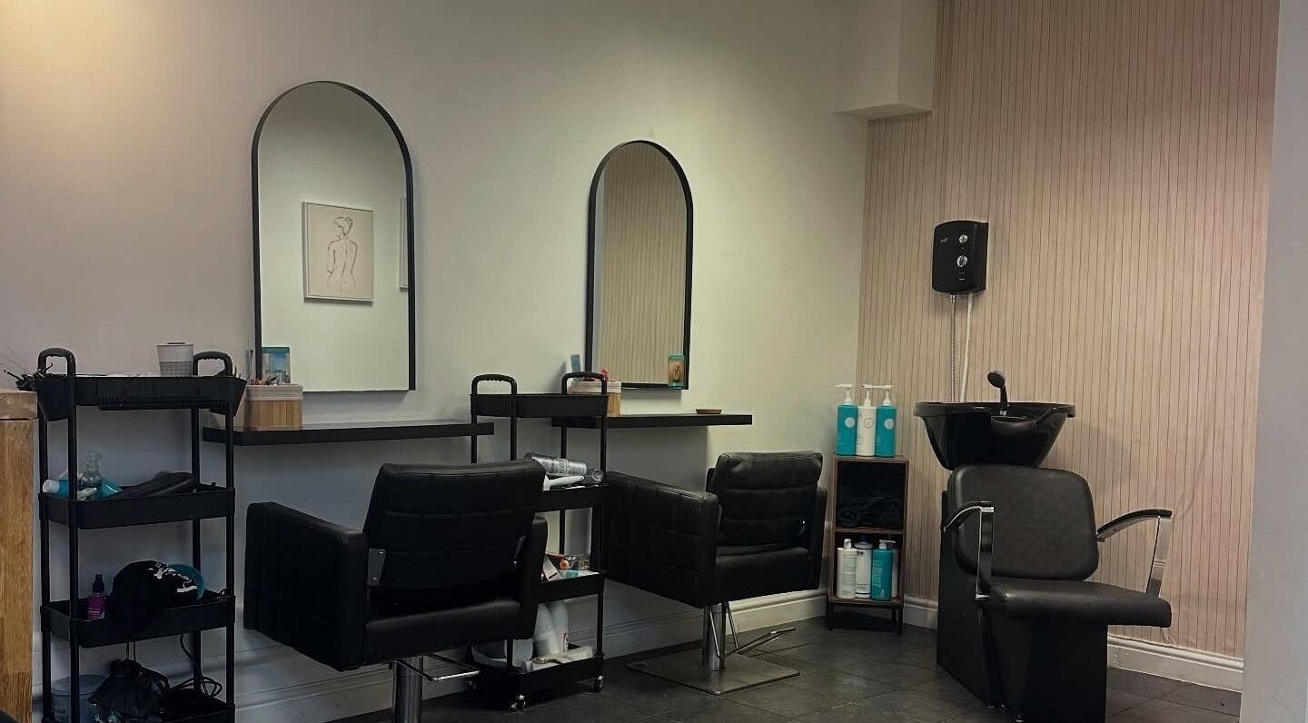 Chic salon interior at Hair Statement, Cannock, England, GB with stylish chairs and mirrors.
