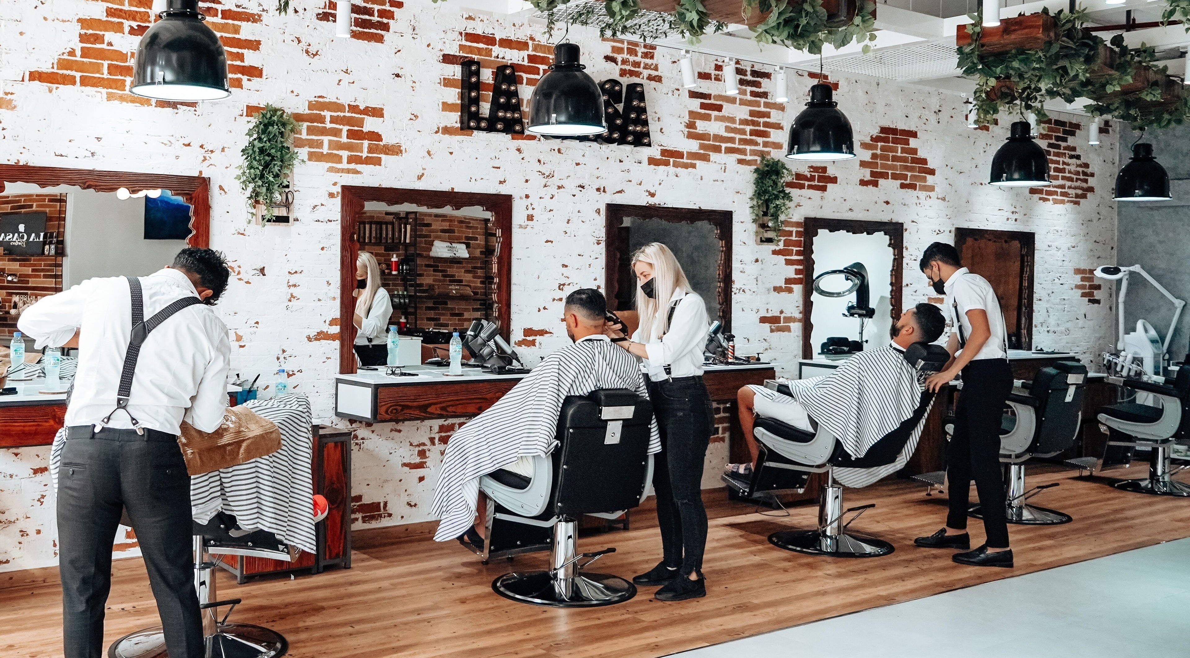 Stylish barbershop at La Casa, Dubai, AE with modern chairs and professional stylists.