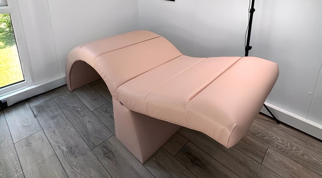Modern pink treatment bed at Emily Rose Beauty, Fareham, England, GB, offering a tranquil wellness experience.
