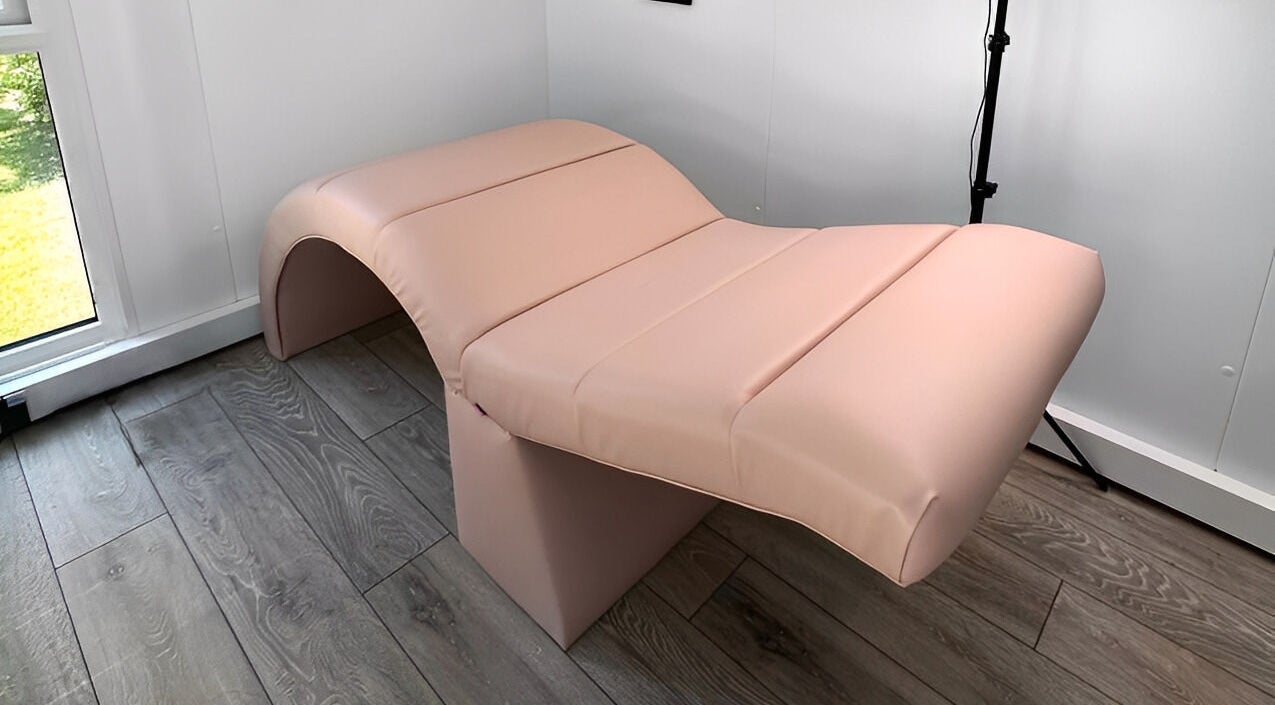 Modern pink treatment bed at Emily Rose Beauty, Fareham, England, GB, offering a tranquil wellness experience.
