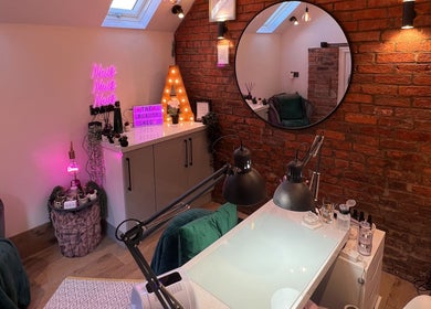 Cozy nail salon interior at The Beauty Shed, Hulland Village, England, GB with neon and stylish decor.
