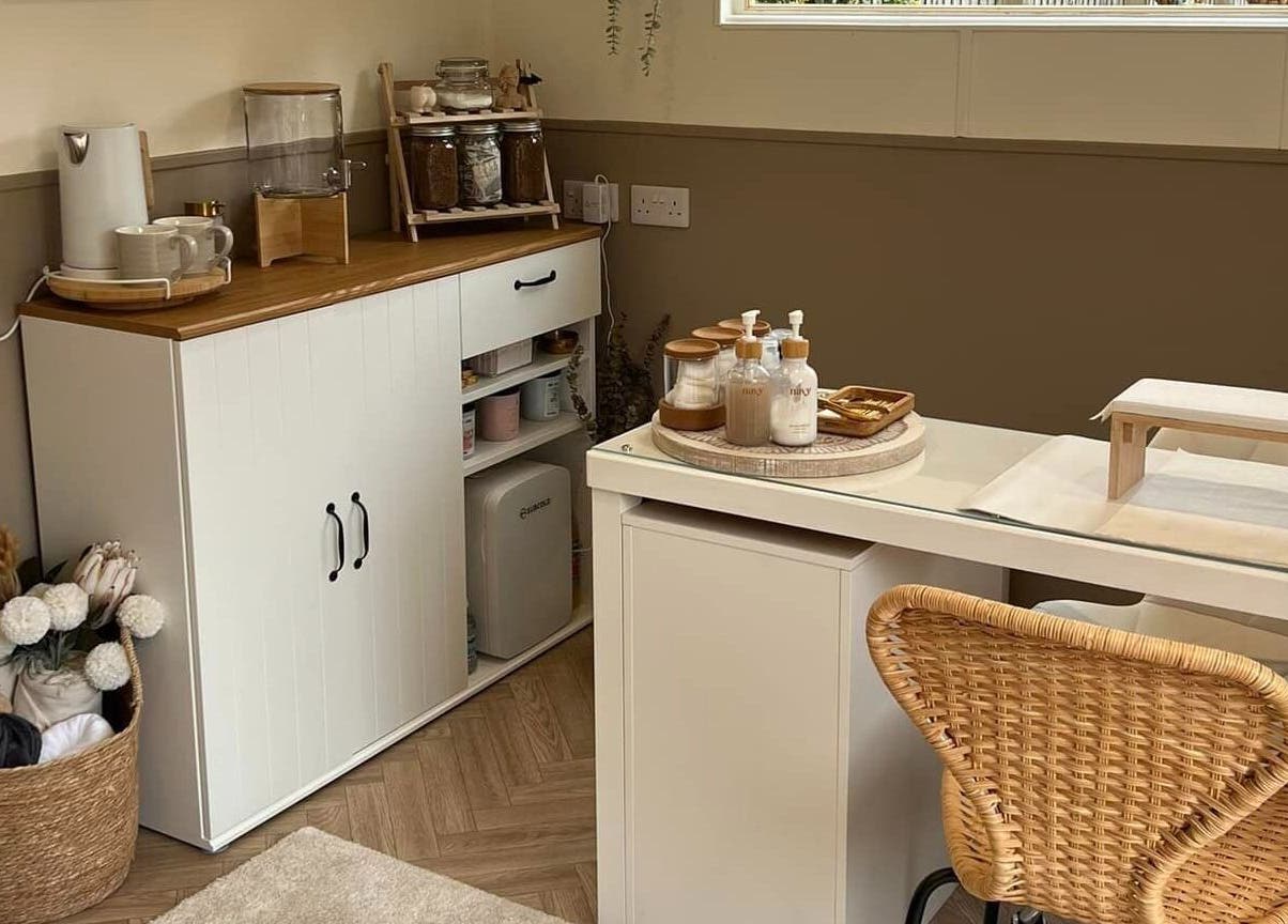 Cozy spa setup at The Beauty Hideaway, Tadcaster, England. Natural tones and wicker chair create a soothing atmosphere.