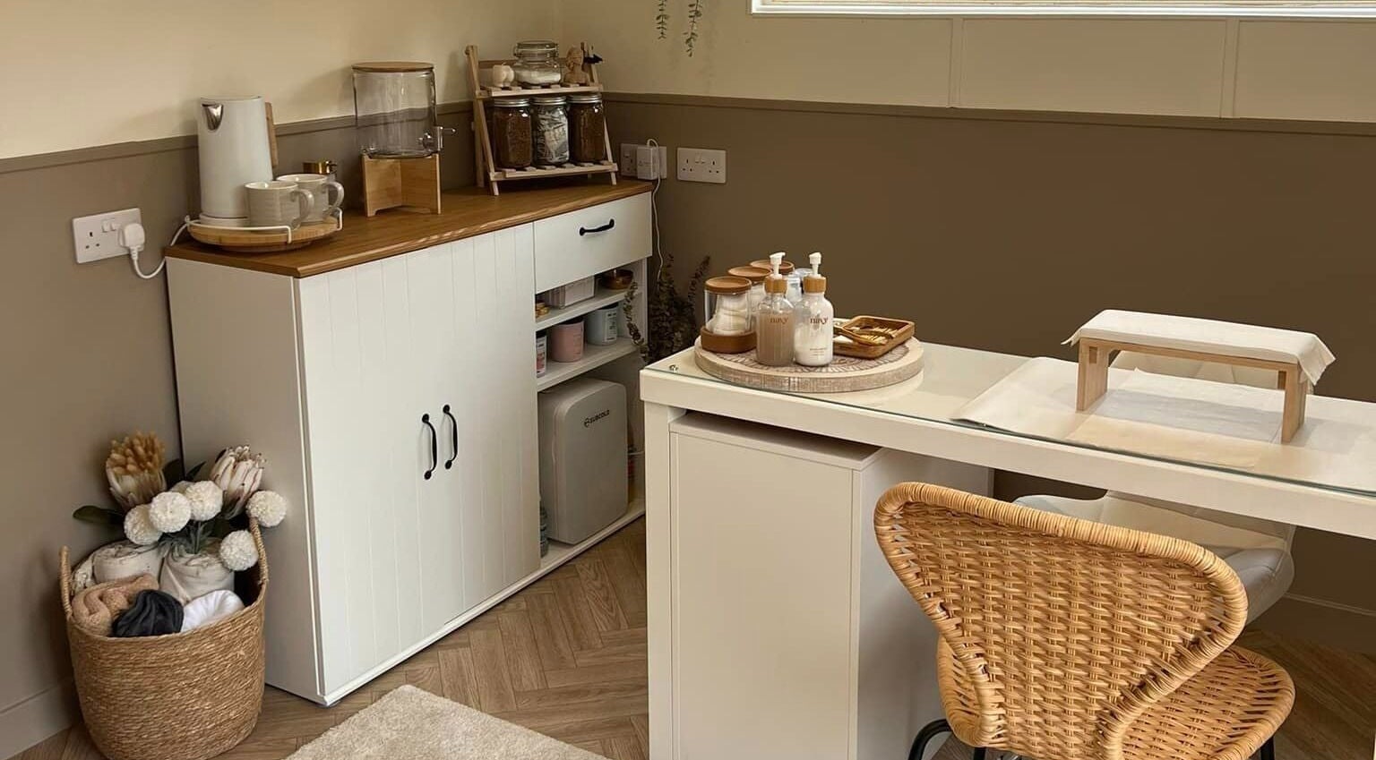 Cozy spa setup at The Beauty Hideaway, Tadcaster, England. Natural tones and wicker chair create a soothing atmosphere.