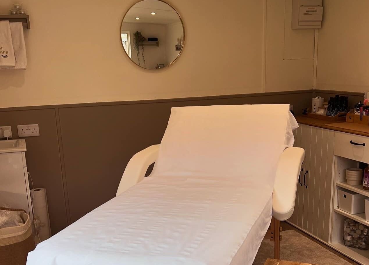 Elegant treatment room at The Beauty Hideaway in Tadcaster, England, GB, featuring a comfortable massage table.