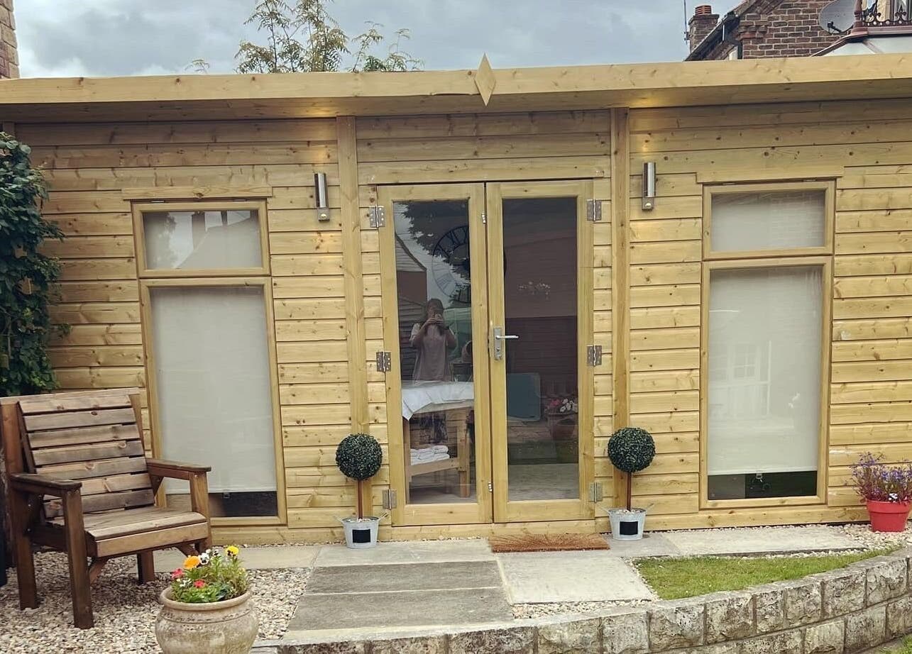 Wooden spa cabin at The Beauty Hideaway, Tadcaster, England, GB, offering a tranquil wellness experience.