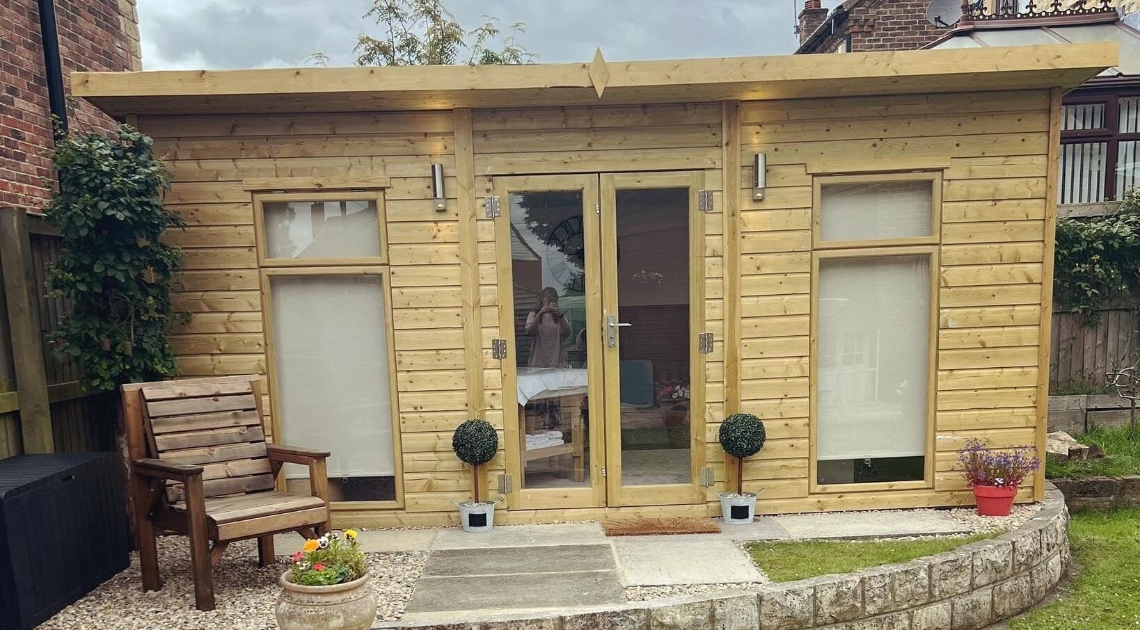 Wooden spa cabin at The Beauty Hideaway, Tadcaster, England, GB, offering a tranquil wellness experience.