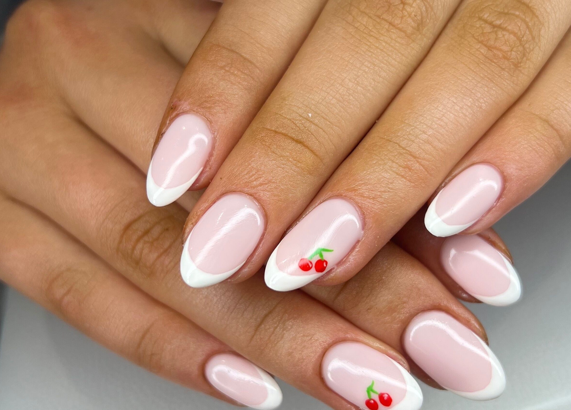 Elegant French manicure with cherries at The Beauty Hideaway, Tadcaster, England, GB.