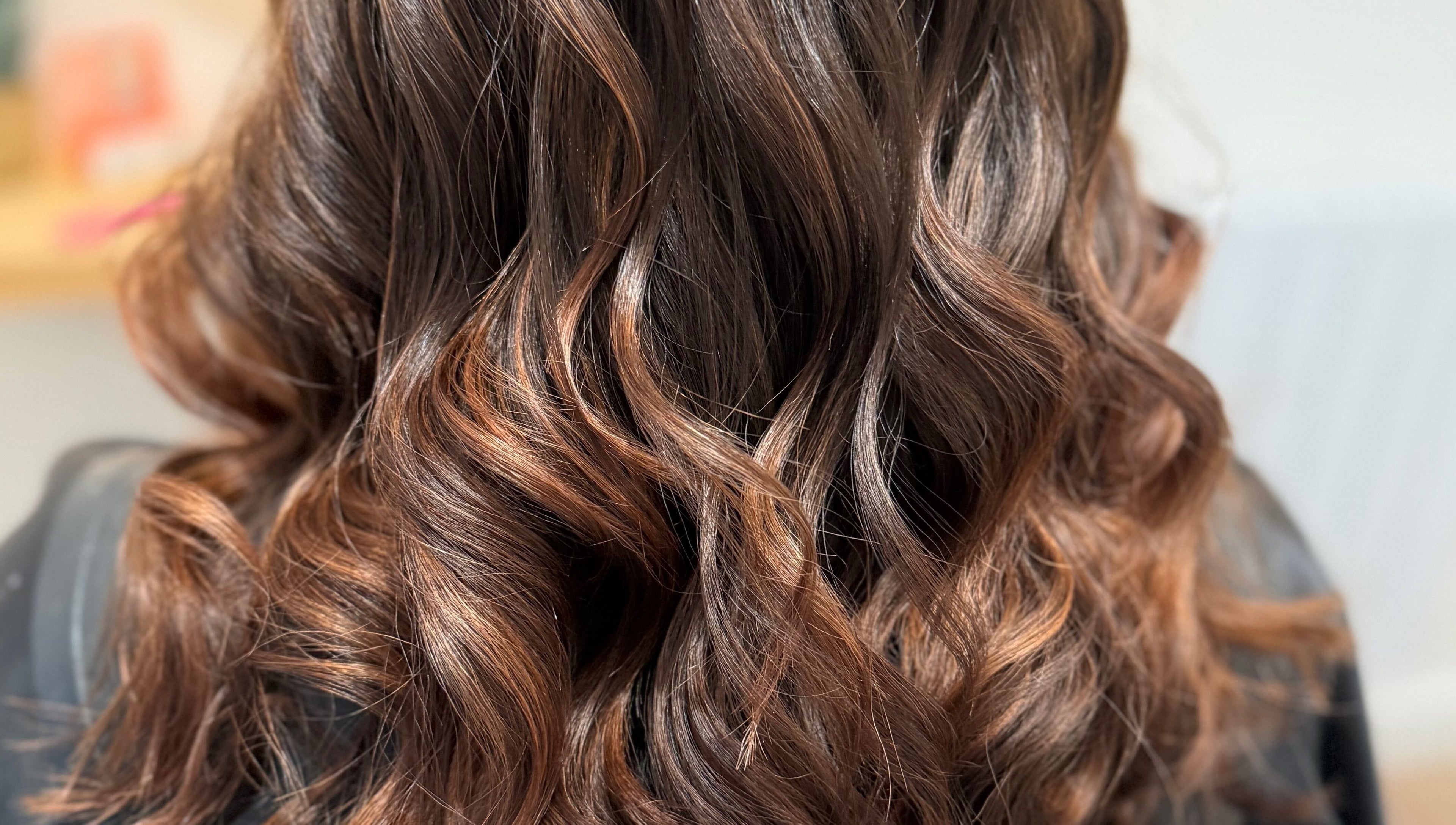 Luxurious wavy hair styled at Rebecca May, Bristol, England, GB, showcasing expert craftsmanship and sheen.