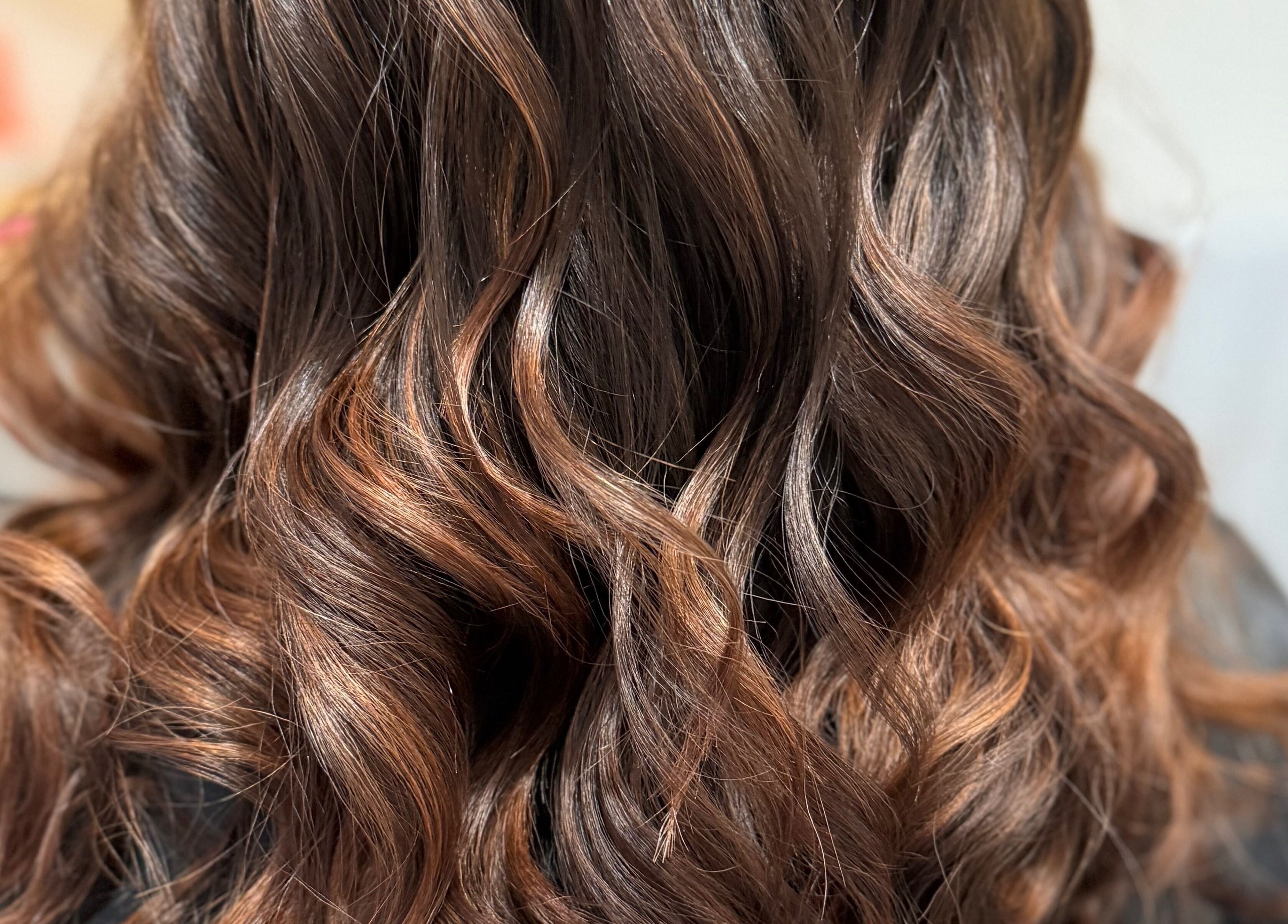 Luxurious wavy hair styled at Rebecca May, Bristol, England, GB, showcasing expert craftsmanship and sheen.