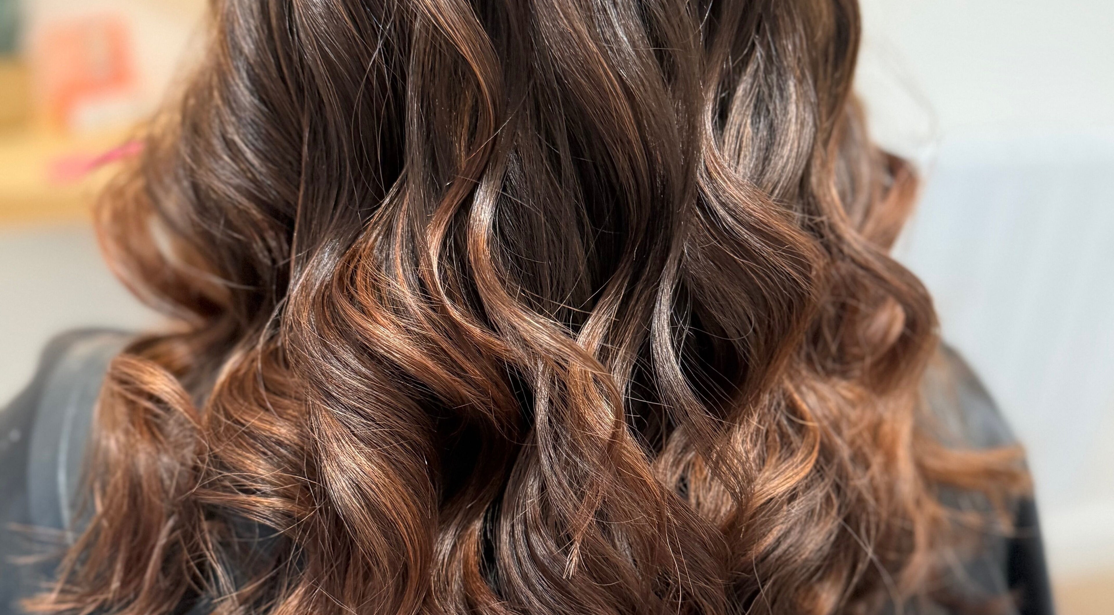 Luxurious wavy hair styled at Rebecca May, Bristol, England, GB, showcasing expert craftsmanship and sheen.