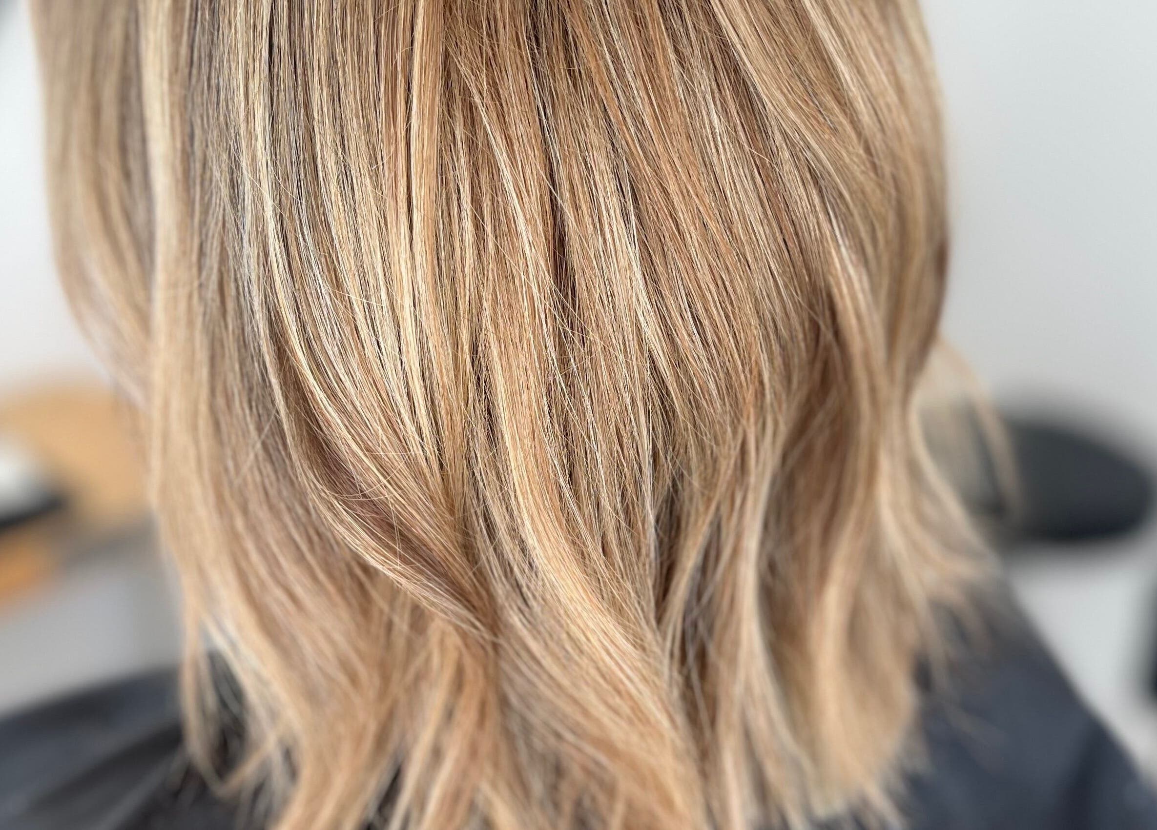 Chic blonde hair styled at Rebecca May salon in Bristol, England, GB, showcasing silky texture and vibrant color.