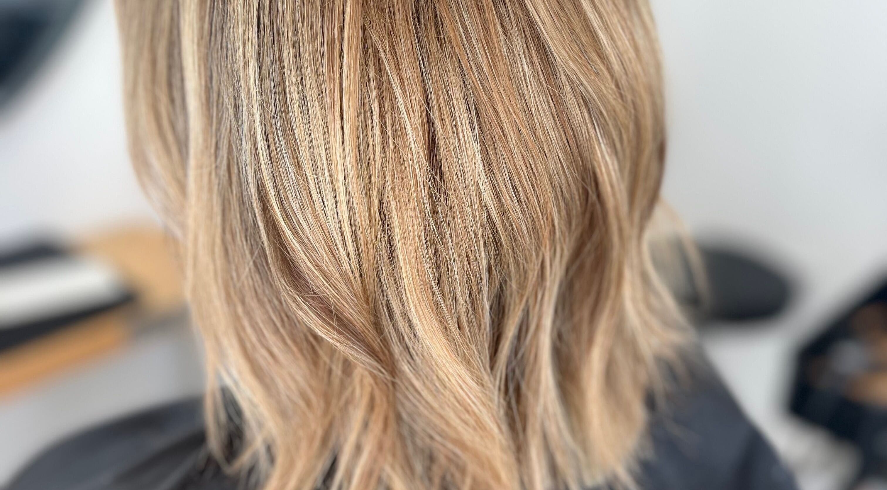 Chic blonde hair styled at Rebecca May salon in Bristol, England, GB, showcasing silky texture and vibrant color.