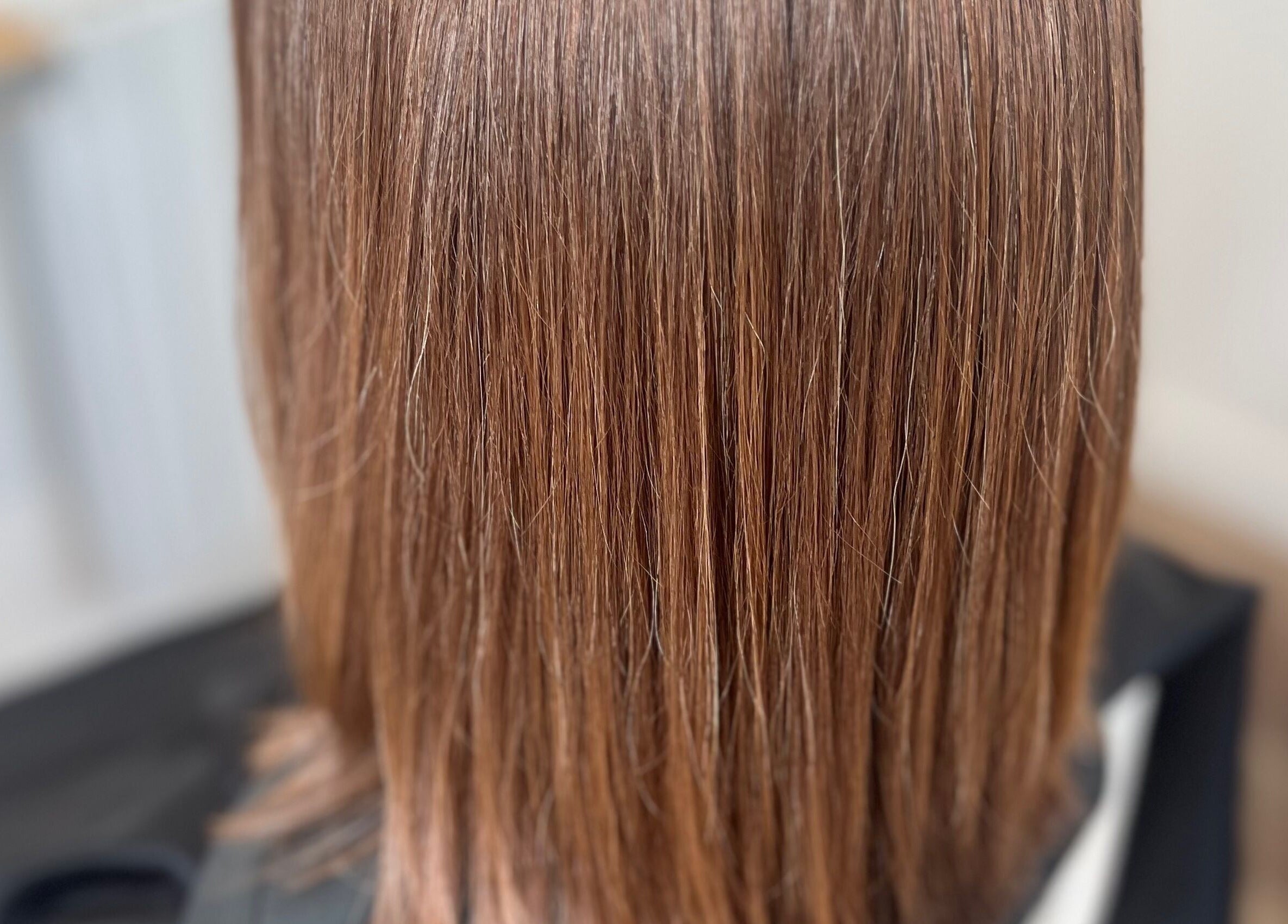 Smooth brunette hair at Rebecca May salon in Bristol, England, GB showcasing expert styling and care.