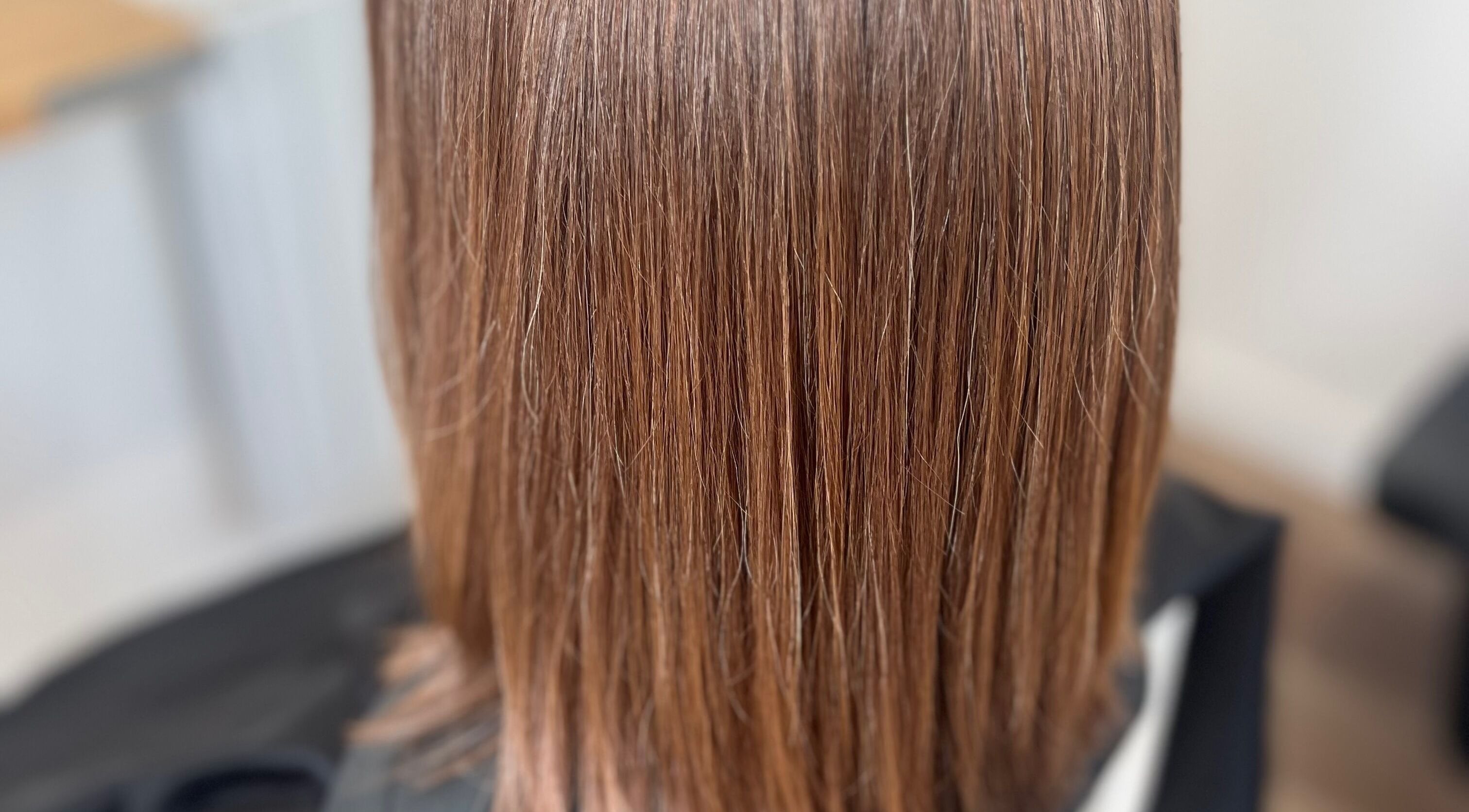 Smooth brunette hair at Rebecca May salon in Bristol, England, GB showcasing expert styling and care.
