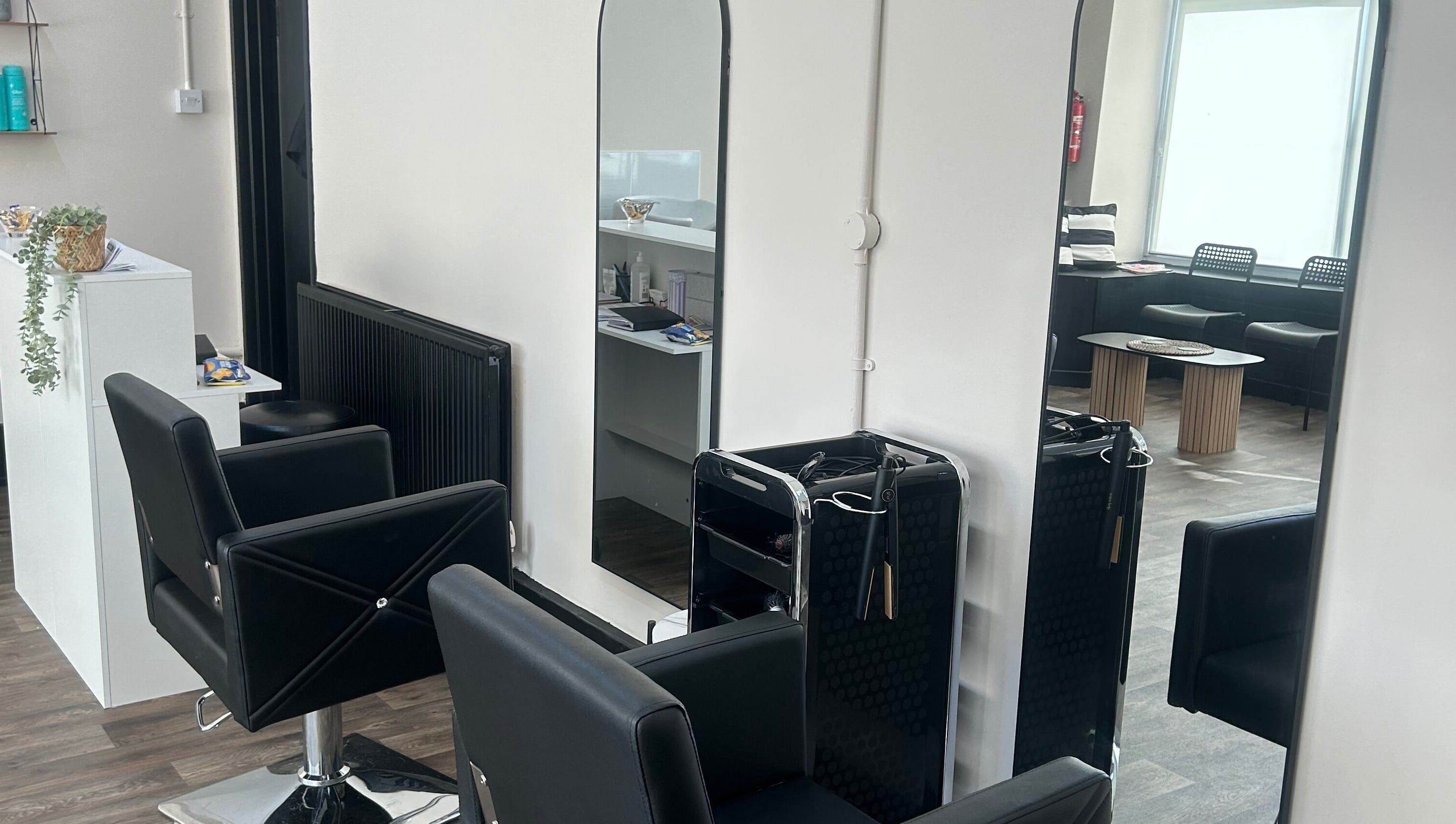 Modern salon chairs and mirrors at Elite hair & beauty in Bolton upon Dearne, England, GB.