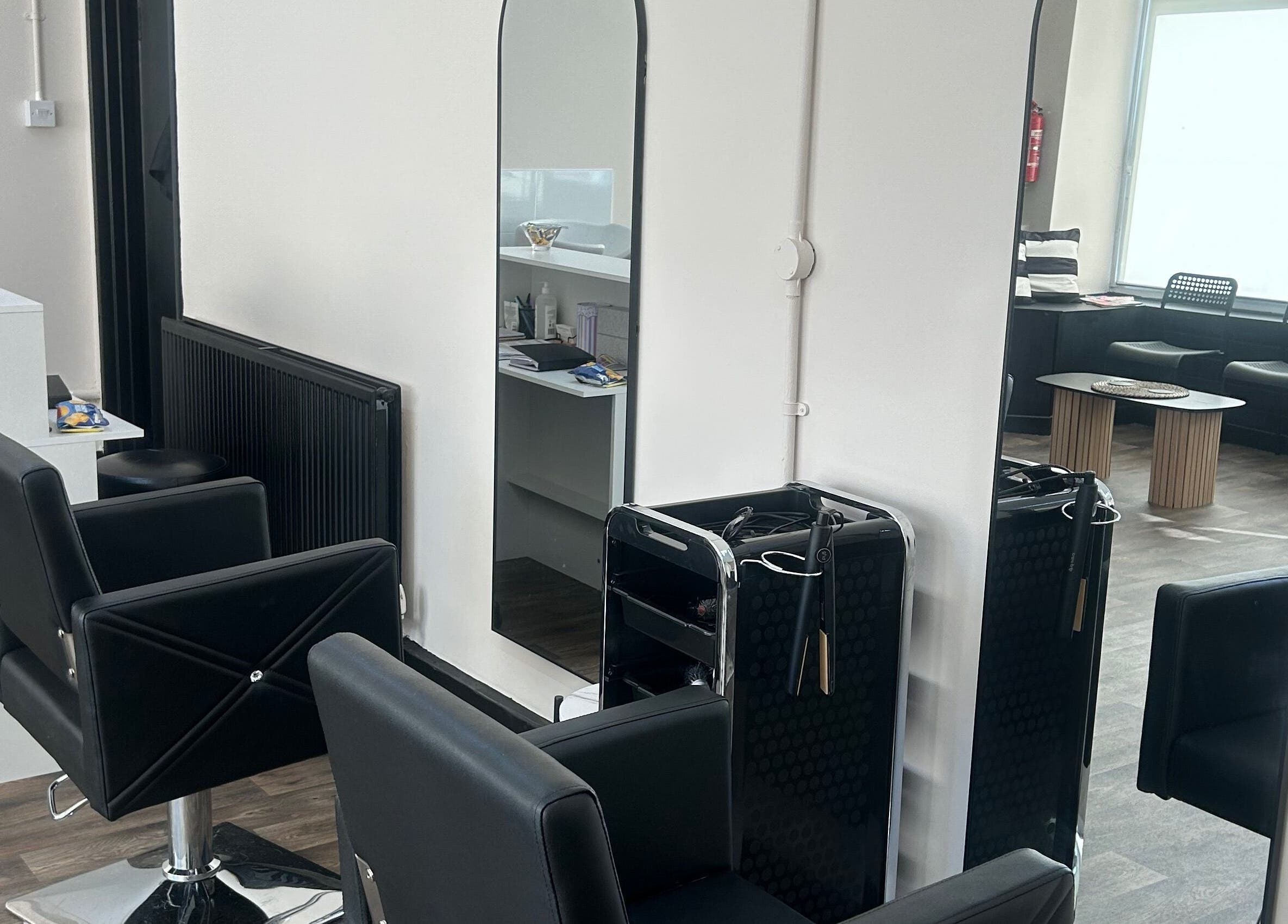 Modern salon chairs and mirrors at Elite hair & beauty in Bolton upon Dearne, England, GB.