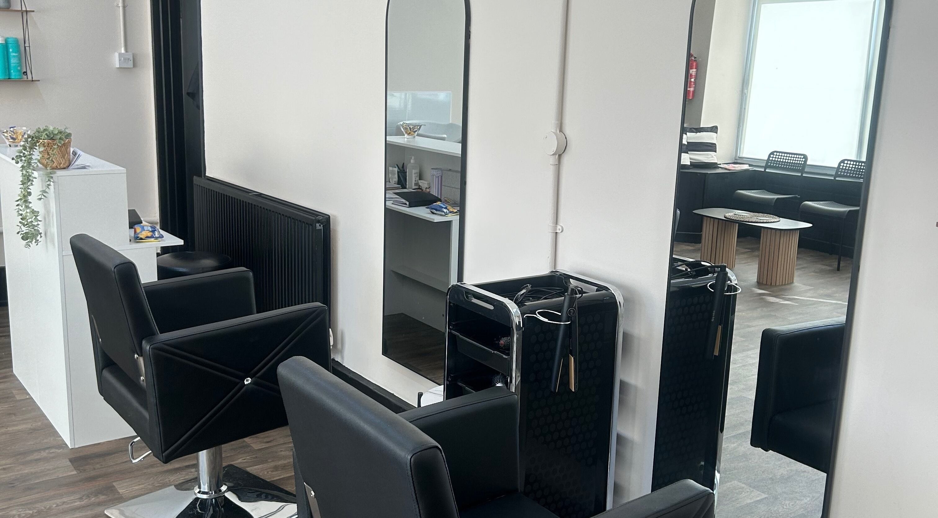 Modern salon chairs and mirrors at Elite hair & beauty in Bolton upon Dearne, England, GB.