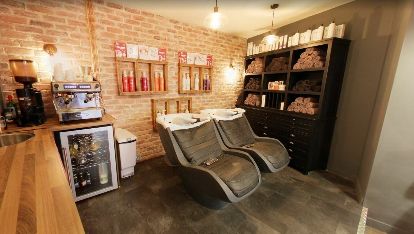 Luxurious hair washing area at Westgate Hair Lounge, York, England, GB with ergonomic chairs and stylish decor.