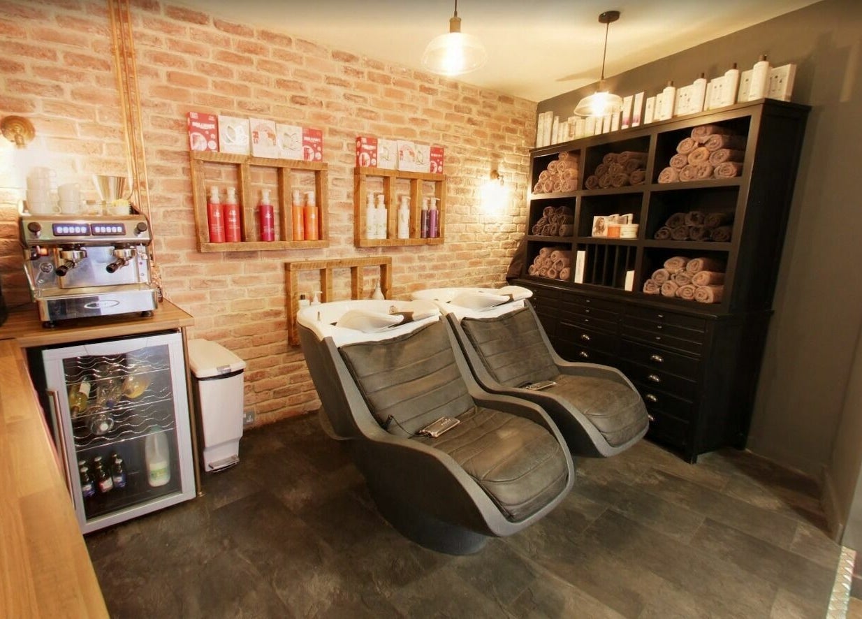 Luxurious hair washing area at Westgate Hair Lounge, York, England, GB with ergonomic chairs and stylish decor.
