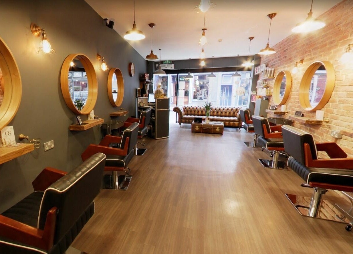 Elegant interior of Westgate Hair Lounge, York, England, GB with modern salon chairs and chic mirrors.