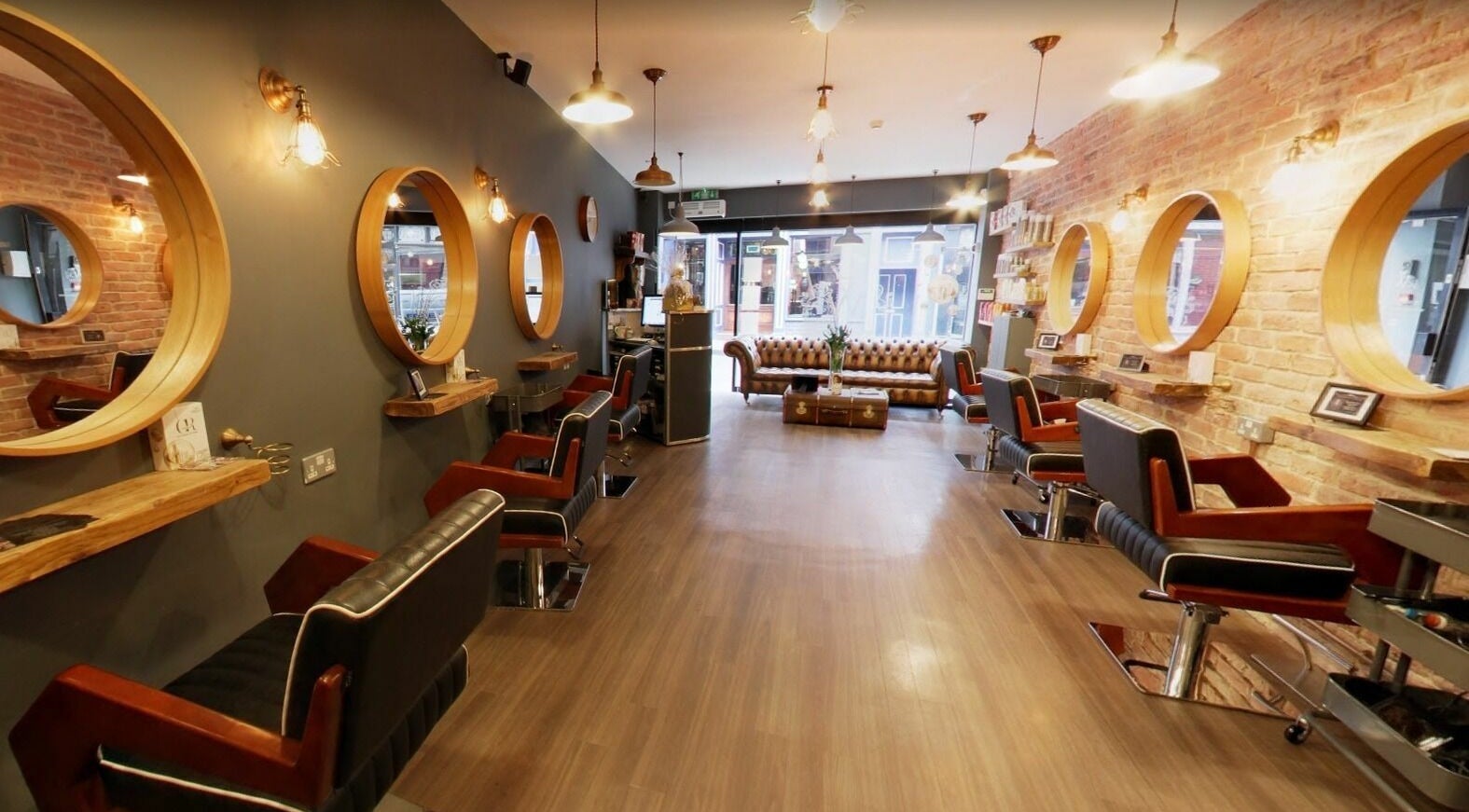 Elegant interior of Westgate Hair Lounge, York, England, GB with modern salon chairs and chic mirrors.