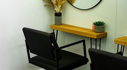 Stylish salon chair and wooden shelf at R&R Organic Hair in London, England, GB, elegantly decorated for a serene ambiance.