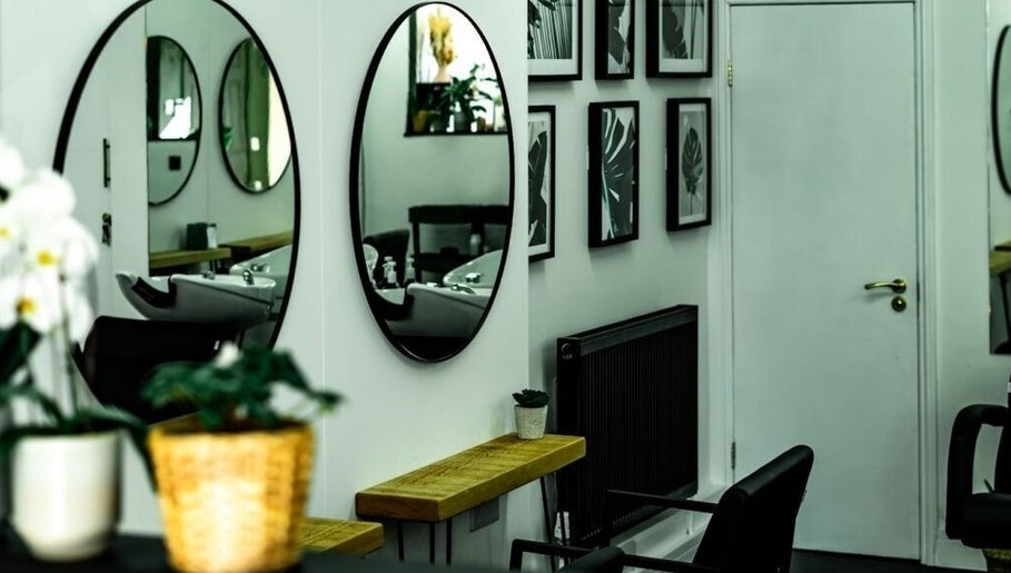 Elegant salon interior with mirrors at R&R Organic Hair, London, England, GB.