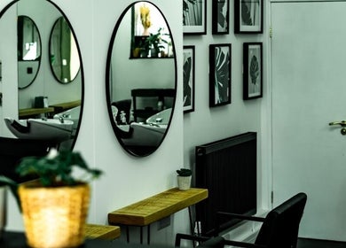 Elegant salon interior with mirrors at R&R Organic Hair, London, England, GB.