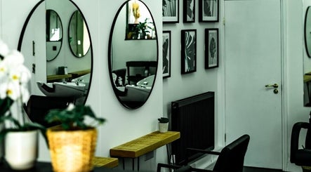 Elegant salon interior with mirrors at R&R Organic Hair, London, England, GB.