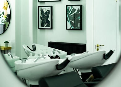 Modern salon interior at R&R Organic Hair, London, England, GB with chic decor and styling stations.
