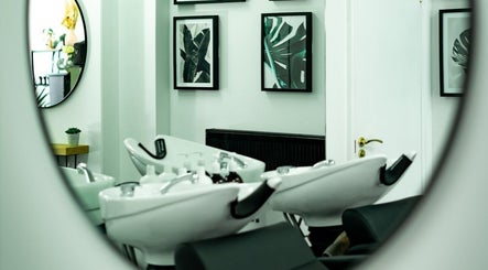 Modern salon interior at R&R Organic Hair, London, England, GB with chic decor and styling stations.