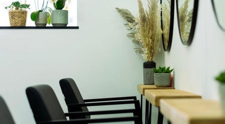 Modern salon seating at R&R Organic Hair, London, England, GB, with plant decor and mirrors enhancing ambiance.