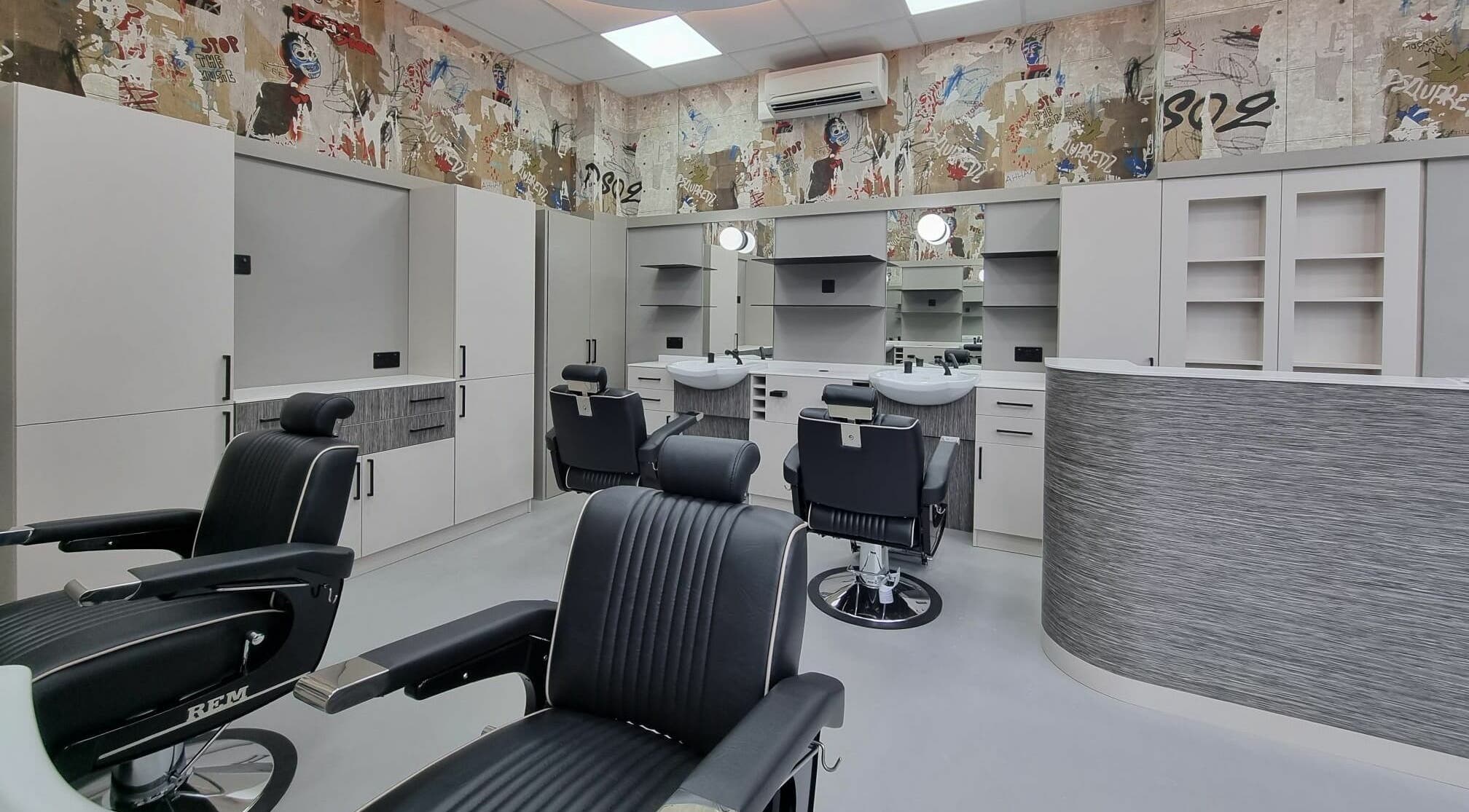 Modern styling chairs at Hair Authors, London, England, GB, showcase sleek interior and professional ambiance.