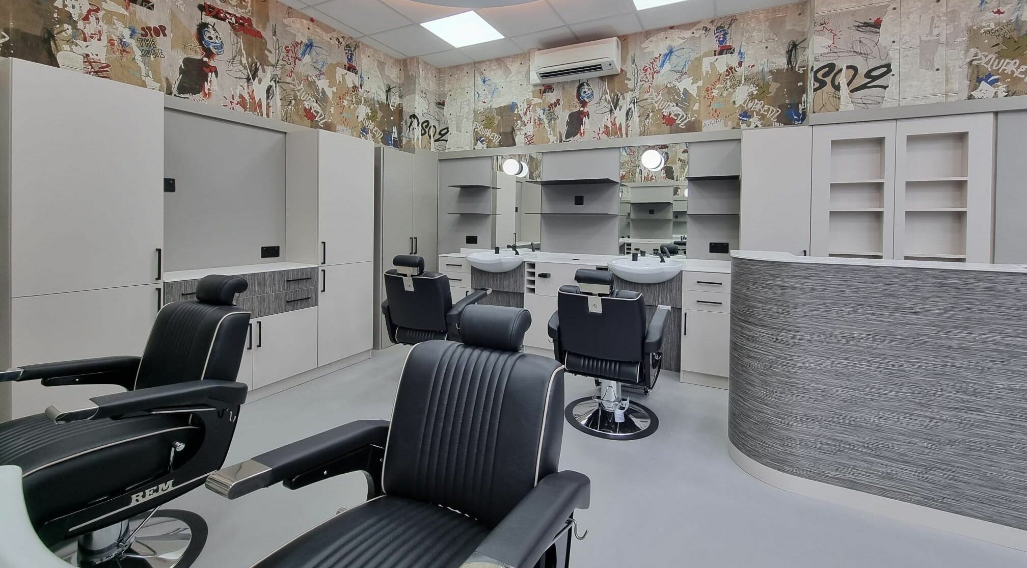 Modern styling chairs at Hair Authors, London, England, GB, showcase sleek interior and professional ambiance.