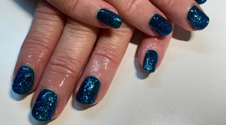Blue glitter nails at Ohana Beauty, Rutherglen, Scotland, GB. A stunning manicure for style and elegance.