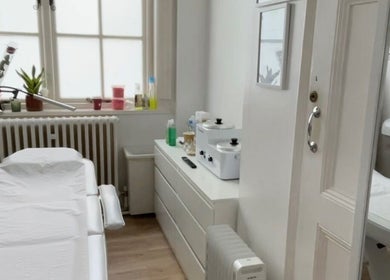 Spacious, serene treatment room at Niz Beauty Base, London, England, GB, with a modern massage bed and decor.